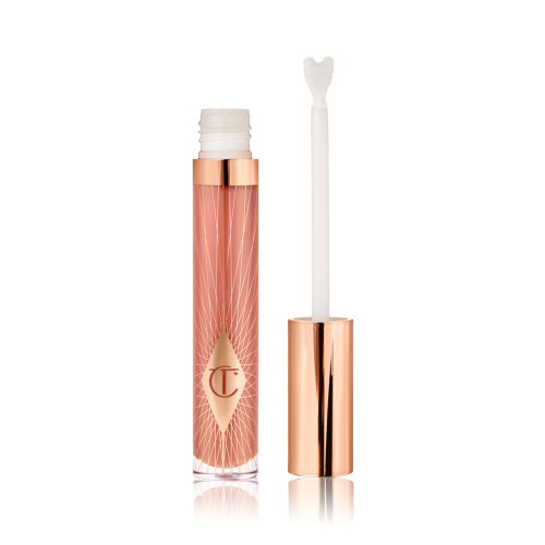 an opened, standard-sized, nude-pink lip gloss with a heart-shaped applicator with a rose gold lid next to it. 