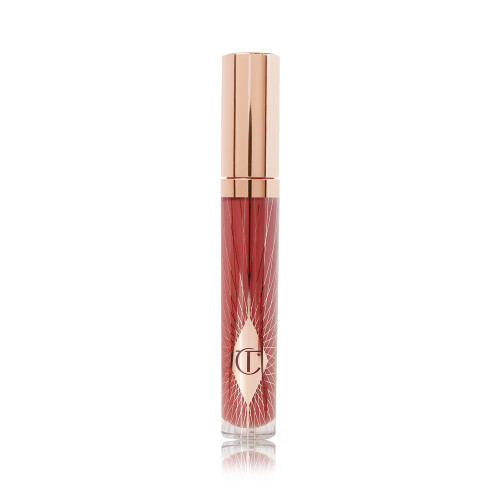 A lip gloss in a berry-pink shade with a gold-coloured lid.