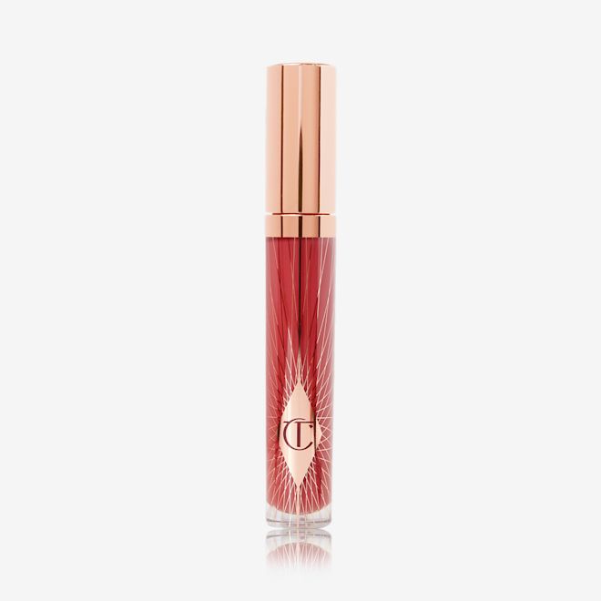 Collagen Lip Bath in Walk of No Shame closed A lip gloss in a berry-pink shade with a gold-coloured lid.