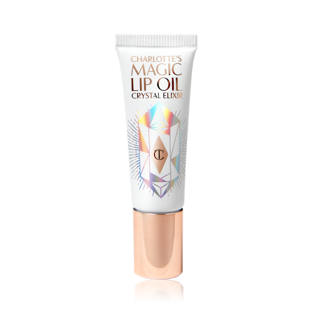 A lip oil in white and rose gold packaging with shimmery geometric shapes on the tube, and a rose-gold-coloured lid. 