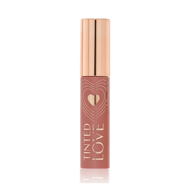 A closed lip and cheek tint with a gold-coloured lid in a soft nude brown-coloured tube.