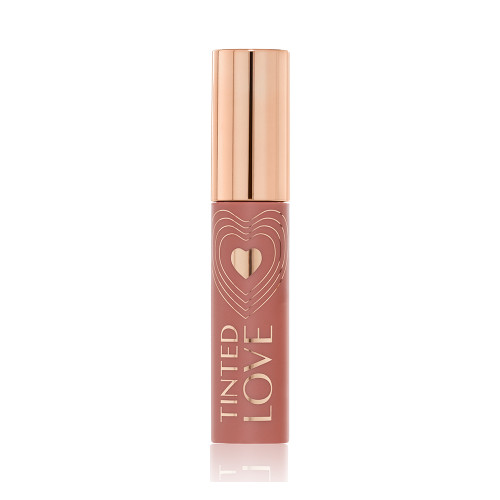 A closed lip and cheek tint with a gold-coloured lid in a soft nude brown-coloured tube.