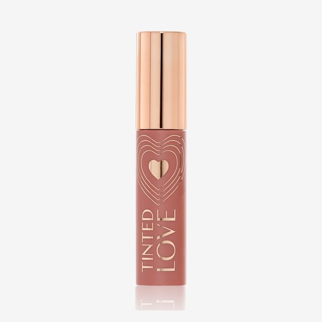 Tinted Love in Santa Euphoria closed A closed lip and cheek tint with a gold-coloured lid in a soft nude brown-coloured tube.