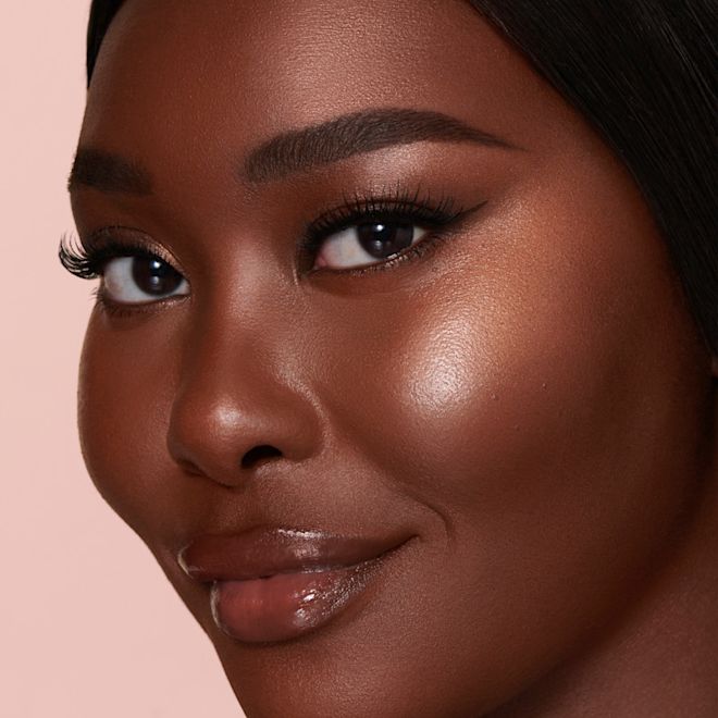 Beauty Light Wand in Pillow Talk Medium on deep dark skin Beauty Light Wand in Pillow Talk Medium on deep dark skin