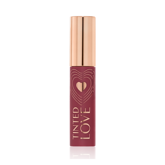 A closed lip and cheek tint with a gold-coloured lid in a dark cherry-red-coloured tube.