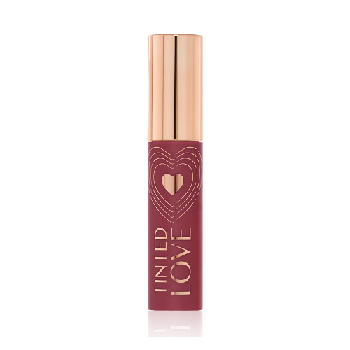 A closed lip and cheek tint with a gold-coloured lid in a dark cherry-red-coloured tube.