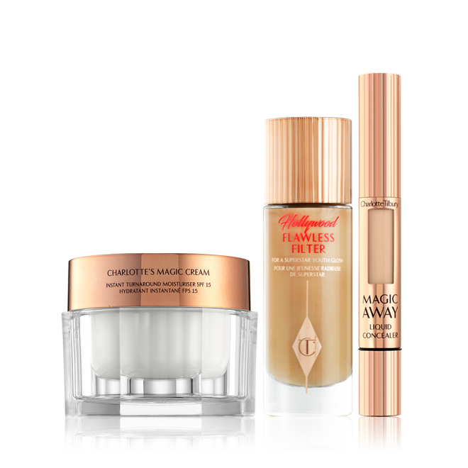 Pealry-white face cream in a glass jar with gold-coloured lid, foundation in a frosted glass bottle with a gold-coloured lid, and creamy concealer in a gold-coloured tube. 