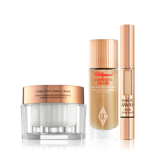 Pealry-white face cream in a glass jar with gold-coloured lid, foundation in a frosted glass bottle with a gold-coloured lid, and creamy concealer in a gold-coloured tube. 