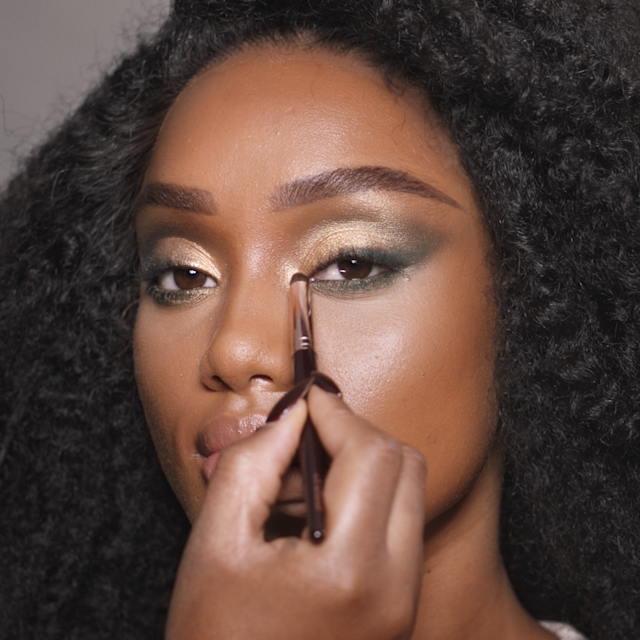 Step 6 of Charlotte's 70s makeup tutorial is to highlight the inner corners and brow bone