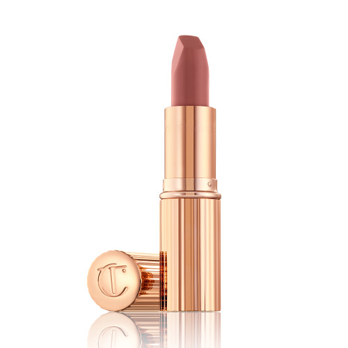 An open, mid-toned muted nude-rose matte lipstick, in sleek, gold-coloured tube. 
