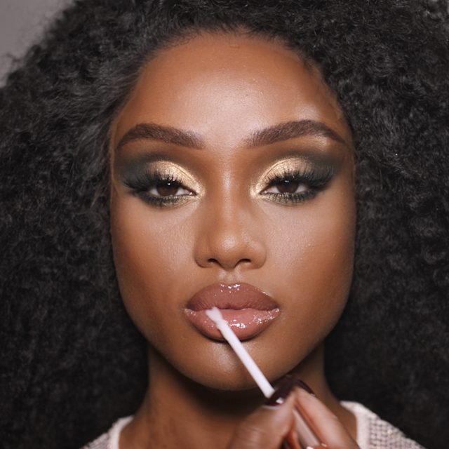 Step 9 in Charlotte's 70s makeup tutorial is to create a glowing glossy lipstick look