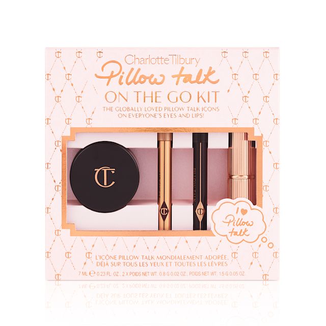A makeup kit that includes a nude pink matte lipstick, nude pink lip liner pencil, warm berry eyeliner pencil, and rose gold cream eyeshadow in a petite glass pot, with a pink-coloured packaging gift box behind the products. 
