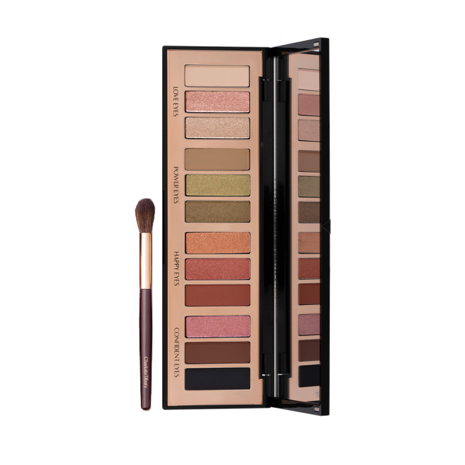 Eyeshadow blending brush in a dark brown and gold colour scheme with an open, 12-pan eyeshadow palette with a mirrored-lid with pink, gold, green orange, red, brown, black, and beige shades to create different smokey eye looks.