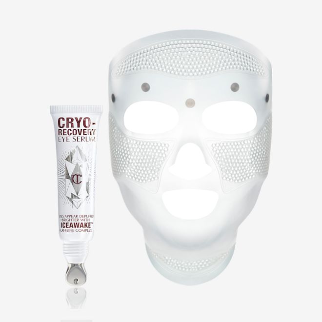Cyro-Recovery Eye Serum and Face Mask A white-coloured face mask with tiny holes all over the forehead and cheeks area, and large eye, nose, and mouth holes so the mask can comfortably sit on any face size or shape and an open white-coloured eye serum tube with silver-colour geometric patterns on the front and text written on it that reads, 'eye appear depuffed and brighter with Iceawake, caffeine complex'