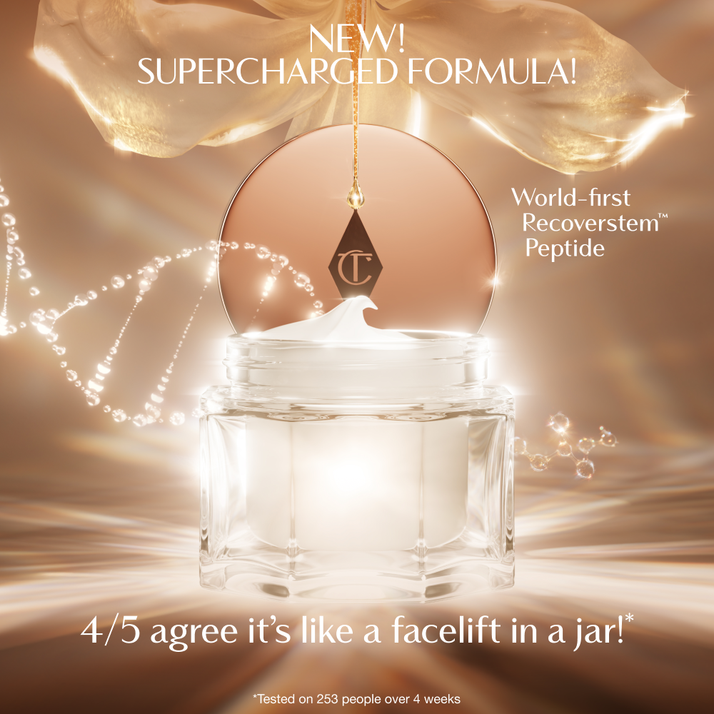A luxurious open jar of cream with a glowing, golden background. The product lid, featuring the Charlotte Tilbury logo, hangs above the jar as a swirl of cream peaks from the top. Text on the image highlights the ‘New! Supercharged Formula’ with a ‘world‑first Recoverstem Peptide,’ and a claim that 4 out of 5 users agree it feels like ‘a facelift in a jar.