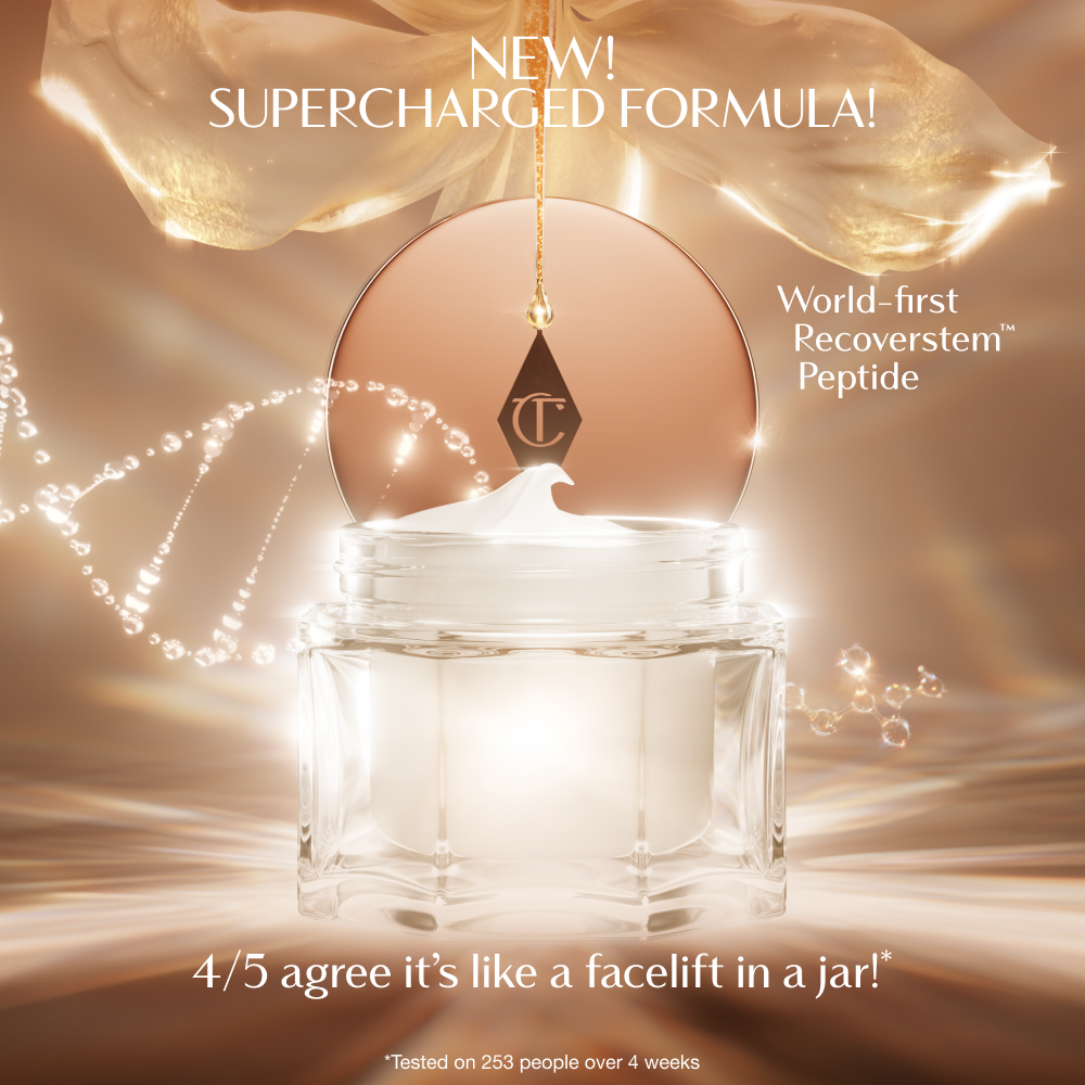 A luxurious open jar of cream with a glowing, golden background. The product lid, featuring the Charlotte Tilbury logo, hangs above the jar as a swirl of cream peaks from the top. Text on the image highlights the ‘New! Supercharged Formula’ with a ‘world‑first Recoverstem Peptide,’ and a claim that 4 out of 5 users agree it feels like ‘a facelift in a jar.