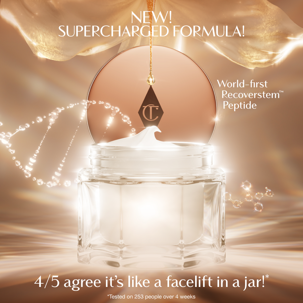A luxurious open jar of cream with a glowing, golden background. The product lid, featuring the Charlotte Tilbury logo, hangs above the jar as a swirl of cream peaks from the top. Text on the image highlights the ‘New! Supercharged Formula’ with a ‘world‑first Recoverstem Peptide,’ and a claim that 4 out of 5 users agree it feels like ‘a facelift in a jar.