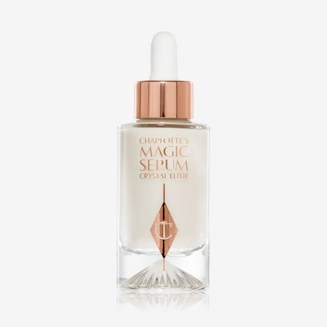 Charlotte's Magic Serum Crystal Elixir Crystal Magic Serum in a clear, glass bottle with a glass dropper in rose-gold packaging.