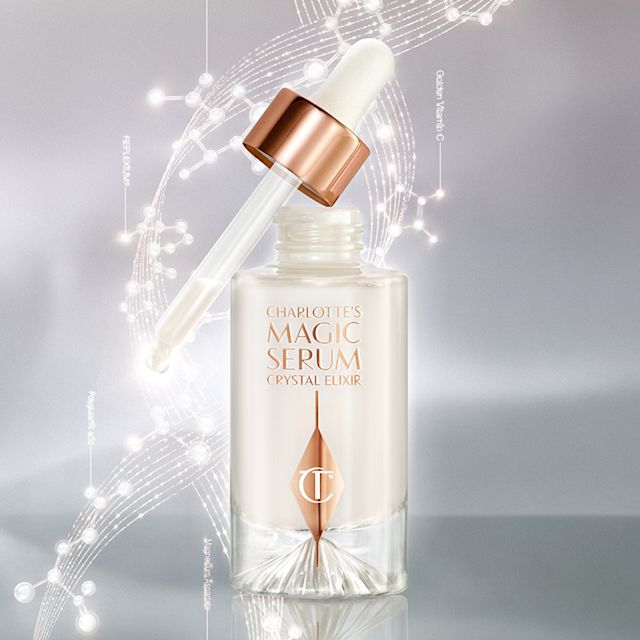 An open, pearly-white face serum in a glass bottle with a dropper applicator, in white and rose gold colour scheme. 