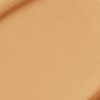Close-up swatch of a skin-like, glowy foundation in a warm, sandy beige shade.