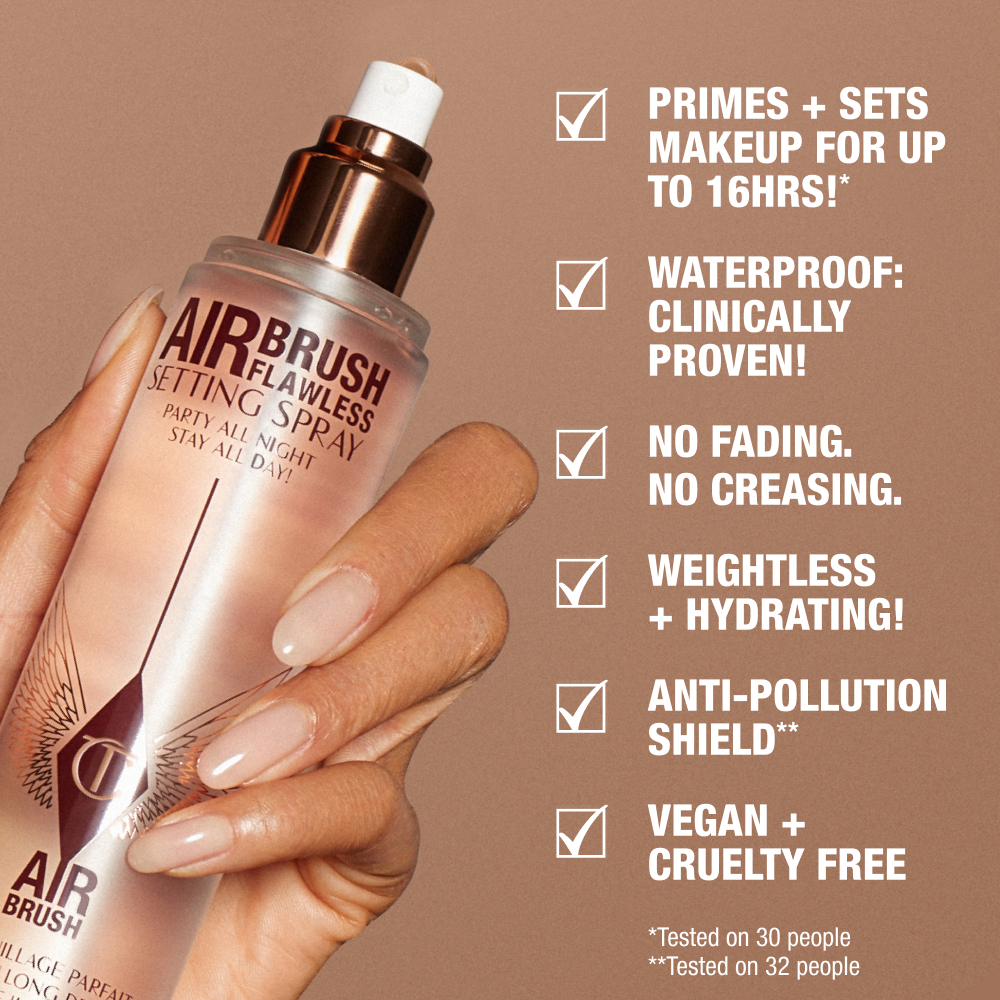 A hand holding a rose-gold bottle of Charlotte Tilbury Airbrush Flawless Setting Spray against a beige background. Text highlights product benefits: primes and sets makeup for up to 16 hours, waterproof, no fading or creasing, weightless and hydrating, anti-pollution shield, vegan and cruelty-free.