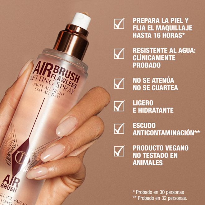 es-SS-KEY-CLAIMS1-1000x1000 A hand holding a rose-gold bottle of Charlotte Tilbury Airbrush Flawless Setting Spray against a beige background. Text highlights product benefits: primes and sets makeup for up to 16 hours, waterproof, no fading or creasing, weightless and hydrating, anti-pollution shield, vegan and cruelty-free.