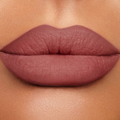Close-up of a model's lips shaded a warm berry-pink. 