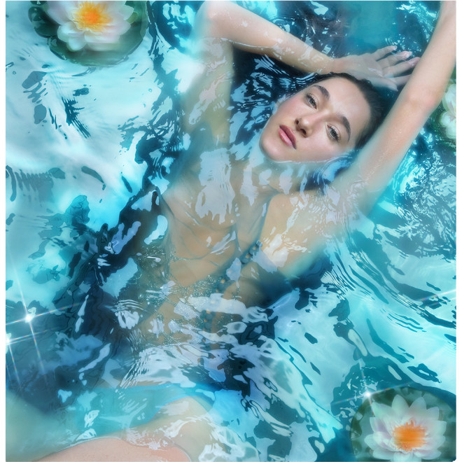Bella Tilbury submerged in water, wearing Calm Bliss: Fresh Aquatic Perfume