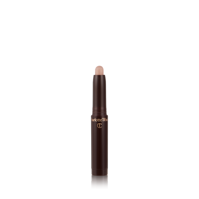 An open, cream eyeshadow wand in a champagne pink shimmer shade.