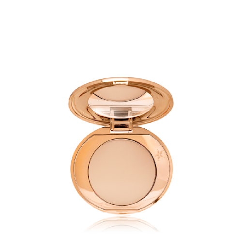 An open, mirrored-lid, mini, pressed powder compact in a medium-beige shade. 