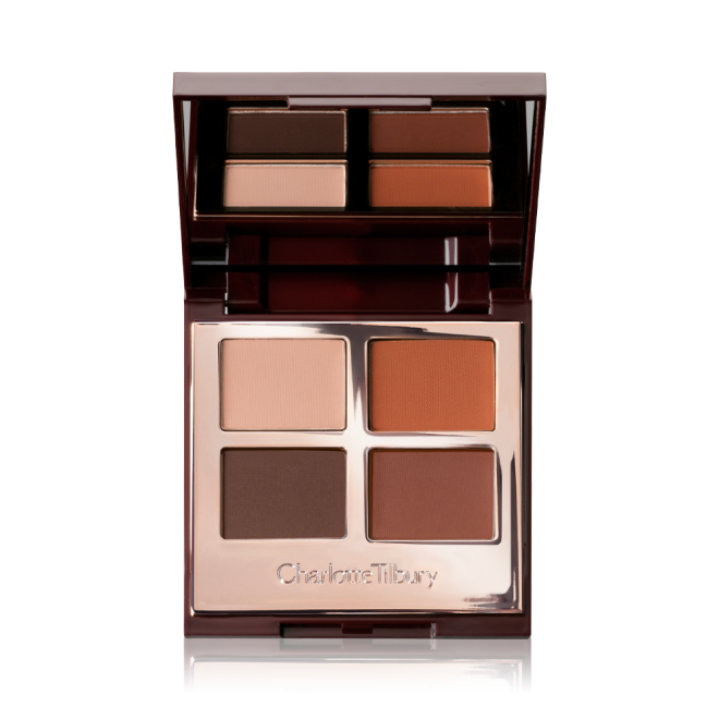 An open, mirrored lid eye shadow palette with four matte eye shadows in shades of brown and champagne.