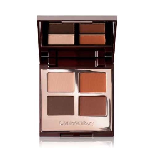 An open, mirrored lid eye shadow palette with four matte eye shadows in shades of brown and champagne.