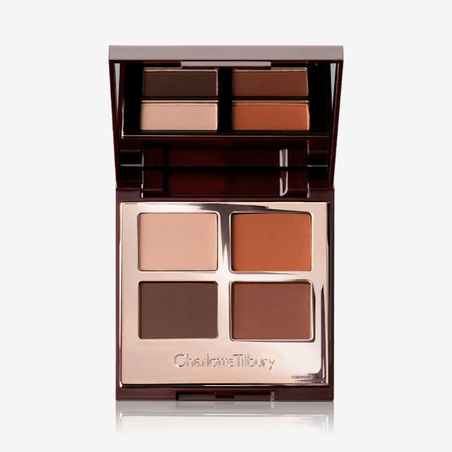Luxury Palette in Desert Haze open An open, mirrored lid eye shadow palette with four matte eye shadows in shades of brown and champagne.