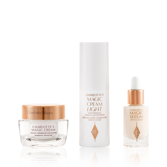 Guardaroba Magic Skincare - Prodotti Travel-size pearly-white cream in a glass jar with a gold-coloured lid, luminous serum in a glass bottle with a white and gold dropper lid, and face cream in a white-coloured bottle.