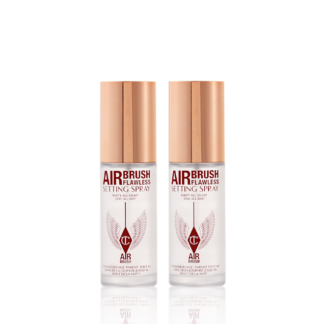Airbrush Flawless Setting Spray Duo travel-size closed Two, identical, mini, setting sprays in clear bottles with gold-coloured lids.