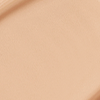 Close-up swatch of a skin-like, glowy foundation in a warm, peachy beige shade.