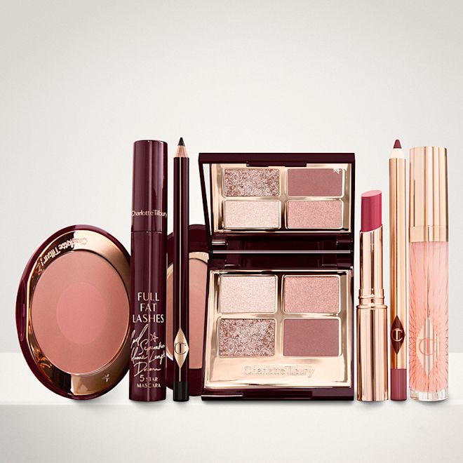 The Supermodel kit for Fair, Light and Medium tones displayed An open two-tone blush in cool-toned brown and warm pink with a mascara, eyeliner pencil, quad eyeshadow palette with shimmery and matte brown and golden shades, an open lipstick in nude red, lip liner pencil in maroon and a lip gloss in nude pink.
