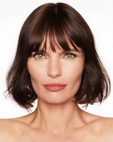 Medium-light-tone model with hazel eyes wearing a rusty rose-coloured lipstick with a moisturising, satin-finish.