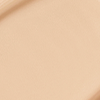 Close-up swatch of a skin-like, glowy foundation in a warm, light beige shade.