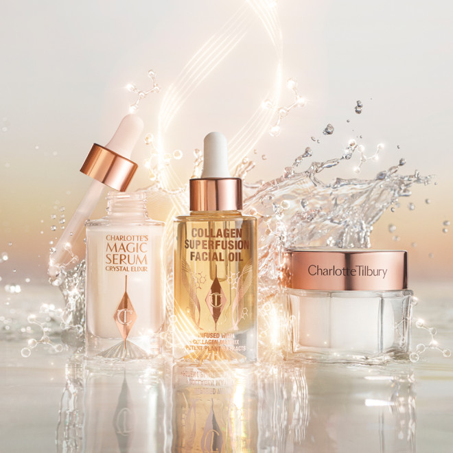 Ivory-coloured luminous serum in an open glass bottle with a dropper lid, light-gold tinted facial oil in a glass bottle with a dropper lid, and pearly-white face cream in a glass jar with a gold-coloured lid.