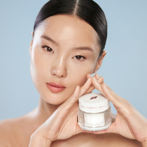 Gia holding Magic Water Cream after skin flooding to hydrate dehydrated skin
