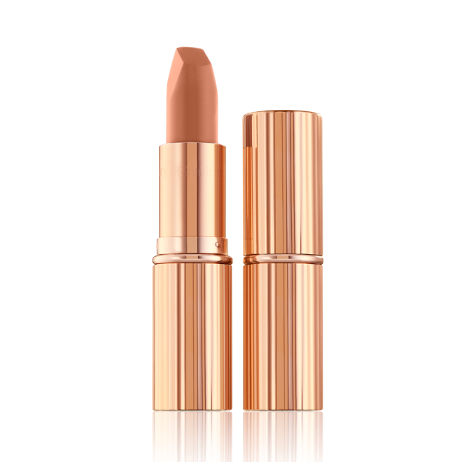 Two lipsticks, with and without lid, in a fresh, neutral nude peach matte shade, in sleek, gold-coloured tubes. 