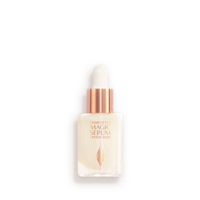 A travel-size, pearlescent serum in a glass bottle with a white rose gold coloured dropper lid. 