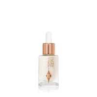 A travel-size, pearlescent serum in a glass bottle with a white rose gold coloured dropper lid. 