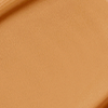 Close-up swatch of a skin-like, glowy foundation in a warm, dark brown shade.