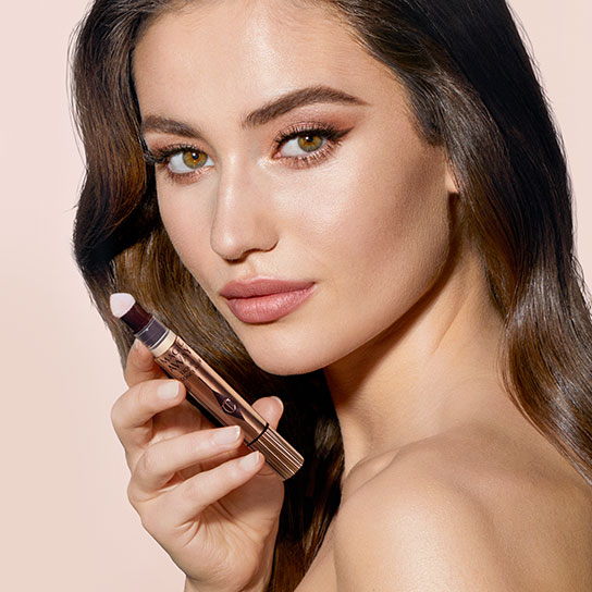 Magic Away model holding the concealer