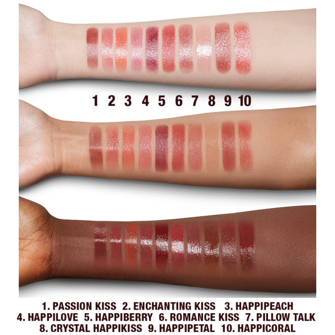Fair, tan, and deep-tone arms with swatches of moisturising lipstick lip balms in ten shades, that are soft brown, nude peach, vibrant coral, soft pink, nude berry pink, berry-rose, medium-pink, sheer pink, wine, and bright coral.