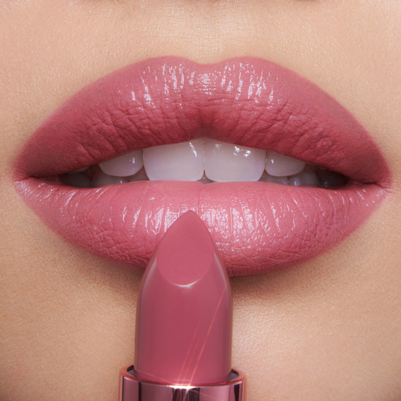 Lip close up of Rose to Fame mauve pink lipstick on fair skin