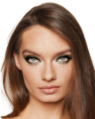 A medium-light-tone, brunette model with green eyes wearing shimmery green, gold, and khaki eyeshadow with teal and khaki-green eyeliner on the upper lid and lower waterline. 