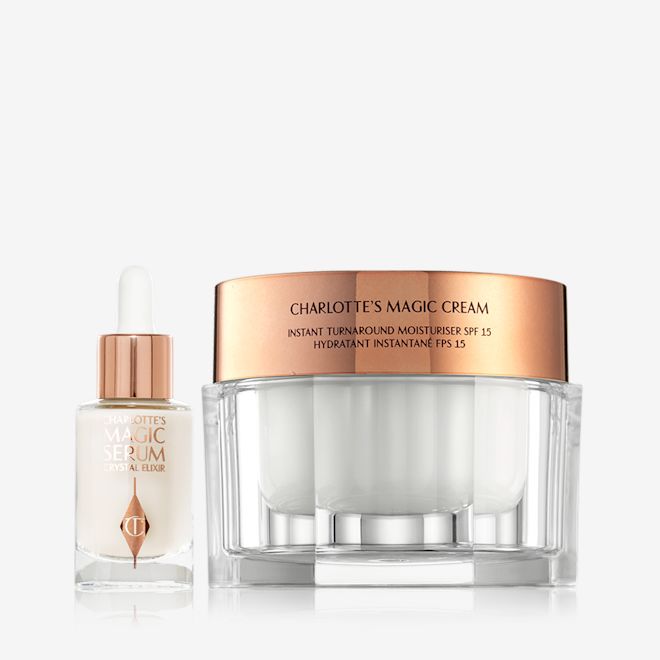 Magic Skin Duo displayed Luminous serum in a glass bottle with a dropper lid with a pearly-white face cream in glass jars with a gold-coloured lid.